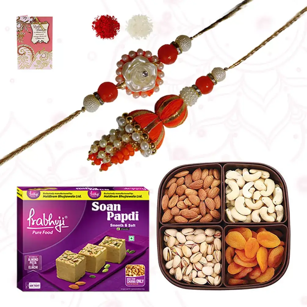 1 Bhaiya Bhabhi rakhi with Dryfruits Platter consisiting of Cashew, raisins, almonds and Apricots and box of Soan Papdi